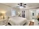 This bedroom features a ceiling fan, an ensuite bathroom with glass shower door and a walk-in closet at 1814 6Th W Ave, Bradenton, FL 34205