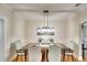 Elegant dining room featuring a modern chandelier and seating for six, perfect for gatherings at 1814 6Th W Ave, Bradenton, FL 34205
