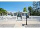 Charming home featuring a white picket fence, a metal roof, and a well-manicured lawn at 1814 6Th W Ave, Bradenton, FL 34205