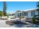 Charming home with manicured lawn and quaint front porch with rocking chairs at 1814 6Th W Ave, Bradenton, FL 34205