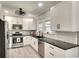 Bright kitchen with white cabinets, stainless steel appliances and a large window allowing plenty of natural light at 1814 6Th W Ave, Bradenton, FL 34205