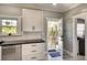 This kitchen has black countertop and a door that leads to the fenced backyard for an indoor-outdoor living experience at 1814 6Th W Ave, Bradenton, FL 34205