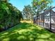 A lush backyard showcases a screened in pool area at 2246 Webber St, Sarasota, FL 34239