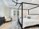 Stylish bedroom featuring a four-poster bed, modern black ceiling fan, and bright natural light at 2246 Webber St, Sarasota, FL 34239