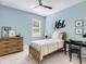 This bedroom has a blue accent wall, a bed, and a dresser at 2246 Webber St, Sarasota, FL 34239
