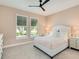 A serene bedroom with neutral colors, two windows and a modern ceiling fan at 2246 Webber St, Sarasota, FL 34239