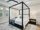 Serene bedroom with a canopy bed, white bedding, modern decor, and soft lighting at 2246 Webber St, Sarasota, FL 34239
