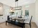 Bright dining room features modern table and chairs illuminated by a contemporary chandelier at 2246 Webber St, Sarasota, FL 34239