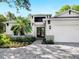 The front entrance to the home features a paved walkway, garden, and a modern front door at 2246 Webber St, Sarasota, FL 34239