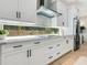 Bright kitchen features white cabinets, long window, stainless steel appliances and modern finishes at 2246 Webber St, Sarasota, FL 34239