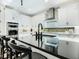 Sleek modern kitchen with black countertops, stainless appliances, white cabinetry, and a stylish faucet at 2246 Webber St, Sarasota, FL 34239