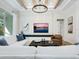 Bright living room featuring a decorative ceiling, modern chandelier, comfortable seating, neutral walls, and flatscreen tv at 2246 Webber St, Sarasota, FL 34239
