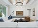 Bright living room featuring a decorative ceiling, modern chandelier, and comfortable seating with white sofa and neutral walls at 2246 Webber St, Sarasota, FL 34239