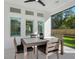 The covered patio features an outdoor dining table with modern furnishings at 2246 Webber St, Sarasota, FL 34239