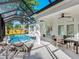 The exterior of the home has a screened-in lanai with a pool and dining area at 2246 Webber St, Sarasota, FL 34239
