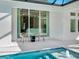 Covered patio featuring seating area next to the pool and spa at 2246 Webber St, Sarasota, FL 34239