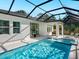An aerial view shows the screened in pool and lanai at 2246 Webber St, Sarasota, FL 34239