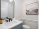 Modern powder room with a sleek mirror, beautiful vanity, and nautical decor at 2246 Webber St, Sarasota, FL 34239