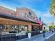 Brick restaurant featuring an inviting entrance, outdoor patio, and American flag at 2246 Webber St, Sarasota, FL 34239