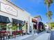 Charming shops with awnings, vintage streetlamp, and plants creating a welcoming ambiance at 2246 Webber St, Sarasota, FL 34239