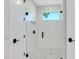 Bright bathroom with a walk-in shower featuring white subway tile, a black shower head, and a glass door at 2246 Webber St, Sarasota, FL 34239