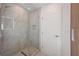 Modern bathroom featuring a glass enclosed shower with a rainfall showerhead and neutral stone tile at 2590 Floyd St, Sarasota, FL 34239