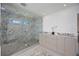 Modern bathroom with double sink vanity and glass enclosed shower with marble tiling at 2590 Floyd St, Sarasota, FL 34239