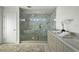 Bright bathroom featuring double sink vanity and spacious glass shower with marble tile at 2590 Floyd St, Sarasota, FL 34239