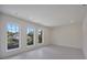 Bright bedroom featuring three windows bringing in natural light, recessed lighting, and tile flooring at 2590 Floyd St, Sarasota, FL 34239