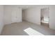 Bright, empty room with light-colored tile flooring, white walls, and neutral trim at 2590 Floyd St, Sarasota, FL 34239
