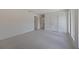 Bright bedroom with tile flooring, featuring three doors and a window for natural light at 2590 Floyd St, Sarasota, FL 34239