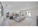 Large bedroom with neutral color palette, recessed lighting, and many windows for ample natural light at 2590 Floyd St, Sarasota, FL 34239