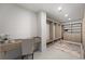 Spacious walk-in closet with custom wood shelving, drawers, and a built-in desk and chair area at 2590 Floyd St, Sarasota, FL 34239