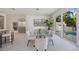 Modern dining area with glass table, contemporary chairs, and view of the pool at 2590 Floyd St, Sarasota, FL 34239