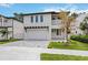 Beautiful two-story home featuring a two-car garage, balcony, and manicured lawn at 2590 Floyd St, Sarasota, FL 34239