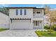 Modern two-story home with a pergola over the garage and decorative balcony railing at 2590 Floyd St, Sarasota, FL 34239