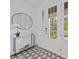 Stylish foyer features decorative tile flooring, modern console table, and elegant front door with glass panels at 2590 Floyd St, Sarasota, FL 34239