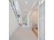 Bright hallway with modern staircase and French doors leading to another room at 2590 Floyd St, Sarasota, FL 34239