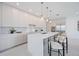A modern kitchen featuring a large island, bar stool seating, and stainless steel appliances at 2590 Floyd St, Sarasota, FL 34239