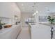 A modern kitchen featuring a large island, bar stool seating, and stainless steel appliances at 2590 Floyd St, Sarasota, FL 34239