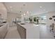 Sleek modern kitchen with marble island, stainless steel appliances, and access to outdoor living at 2590 Floyd St, Sarasota, FL 34239