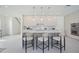 A modern kitchen featuring a large island, bar stool seating, and stainless steel appliances at 2590 Floyd St, Sarasota, FL 34239