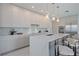 A modern kitchen featuring a large island, bar stool seating, and stainless steel appliances at 2590 Floyd St, Sarasota, FL 34239