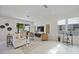 Modern living room with neutral furnishings, artistic wall decor, and sliding glass doors for indoor-outdoor living at 2590 Floyd St, Sarasota, FL 34239