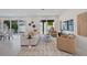 Bright living room boasts neutral furnishings, modern decor, and sliding glass doors to the backyard pool area at 2590 Floyd St, Sarasota, FL 34239