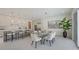 Bright open floor plan featuring a modern kitchen island, dining area, and stylish pendant lighting at 2590 Floyd St, Sarasota, FL 34239
