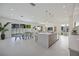 An open living space with a kitchen island, dining area, living room, and pool access at 2590 Floyd St, Sarasota, FL 34239