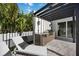 Outdoor kitchen area with a grill, sink, cabinets, and lounge chair at 2590 Floyd St, Sarasota, FL 34239