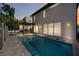 Backyard featuring a stunning pool, outdoor kitchen with grill, and elegant hardscape, perfect for outdoor living at 2590 Floyd St, Sarasota, FL 34239