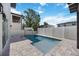 Private pool featuring pavers, fencing, and neighboring homes in a lushly landscaped backyard at 2590 Floyd St, Sarasota, FL 34239